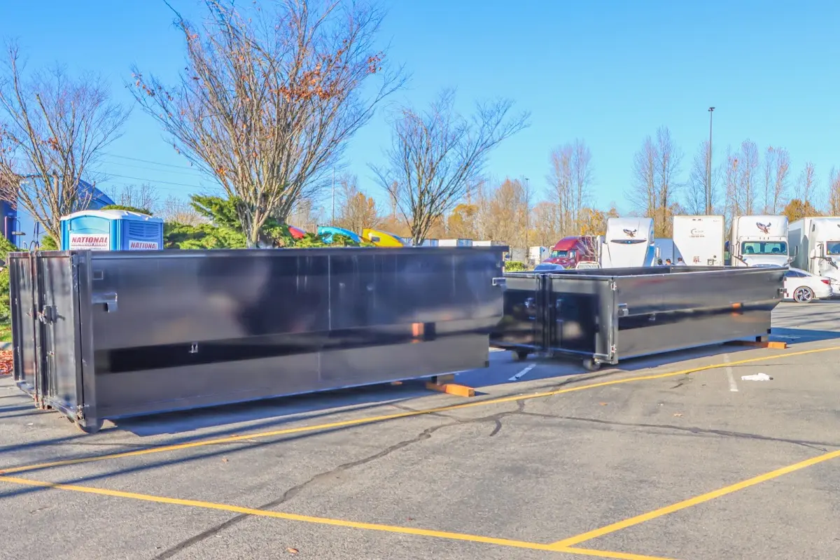 Professional dumpster rental service with roll-off container on residential driveway in Bethel